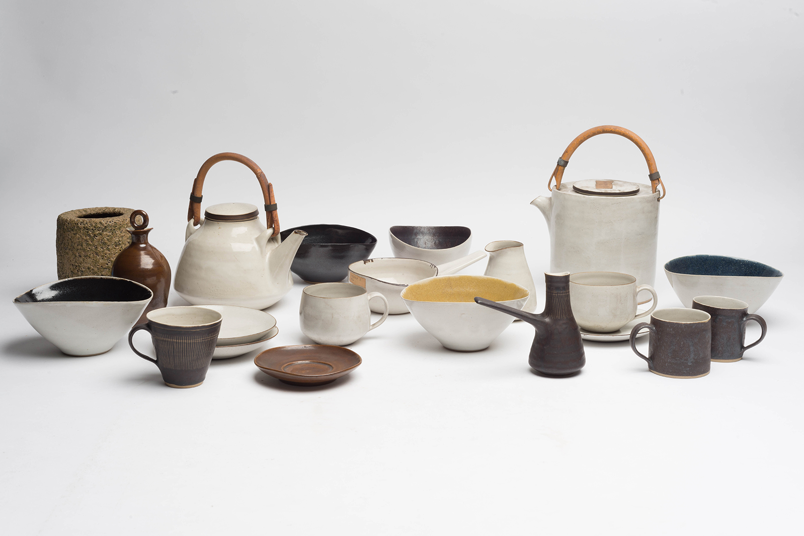Colour photograph showing an assortment of mid 20th century ceramic pots and saucers